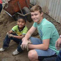 a student with a local child during a planned day of service Day of Service - Study Abroad EdOdyssey